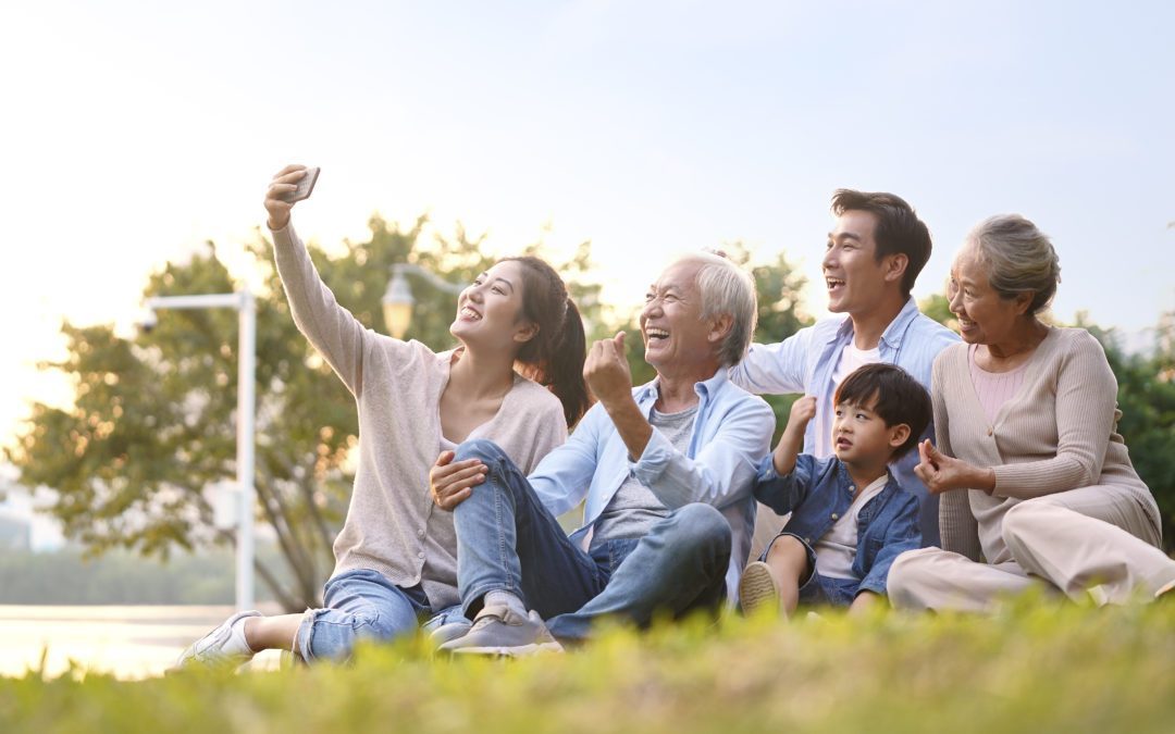 Grandparents with grandkids / heir(s) taking a selfie outside