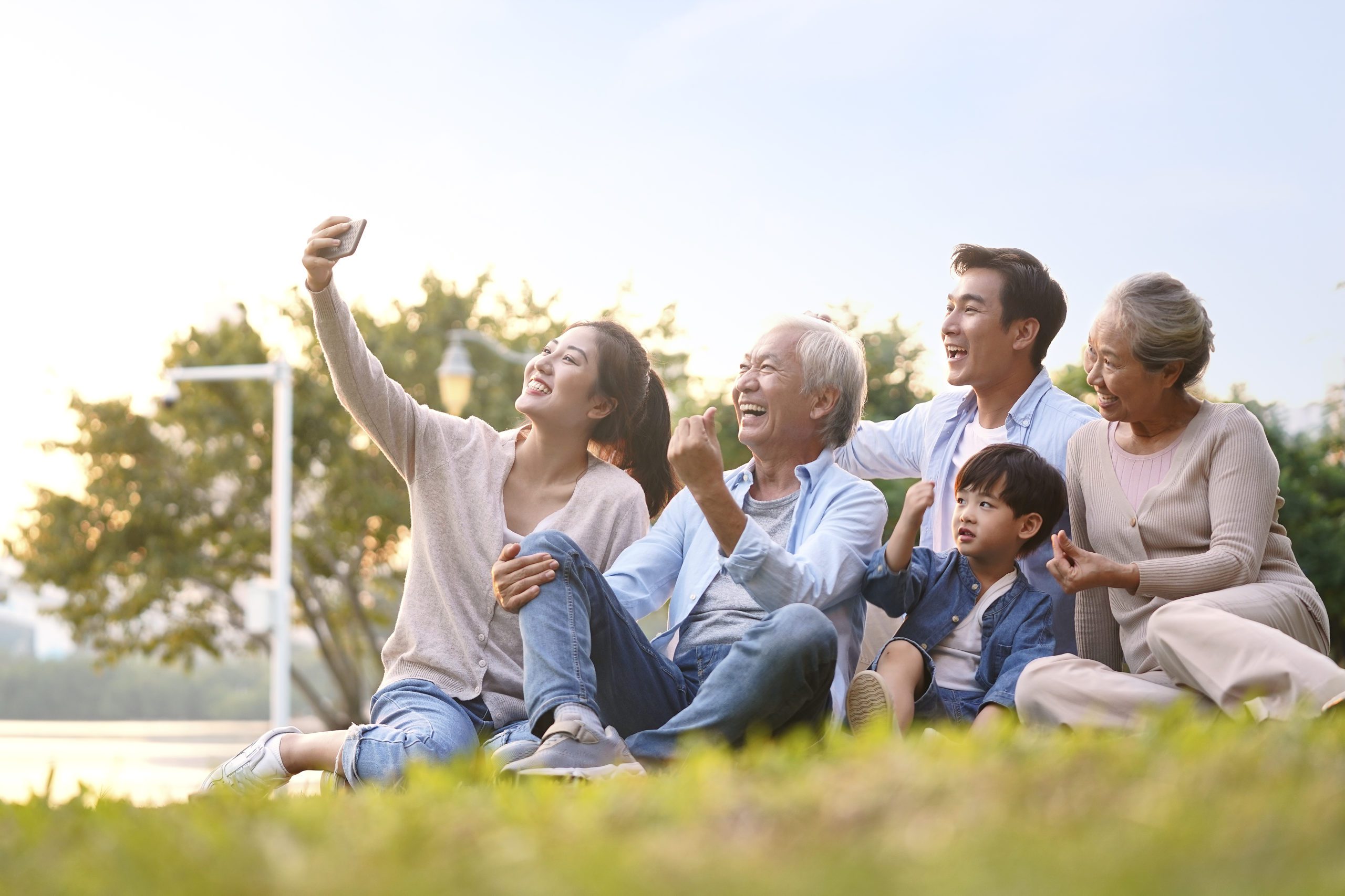 Grandparents with grandkids / heir(s) taking a selfie outside