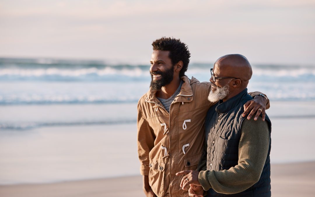 Dad and his son or heir walking on beach