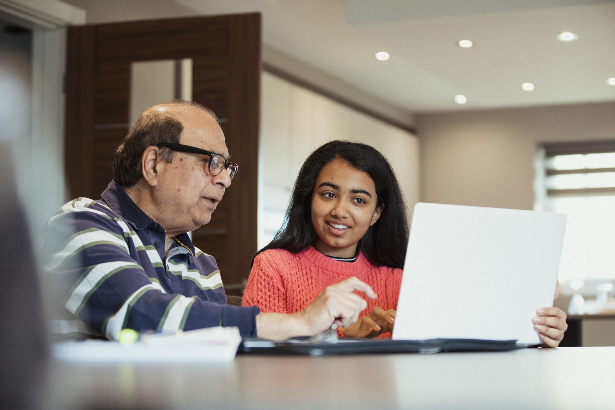 Grandparent showing grandchild their Roth IRA on computer