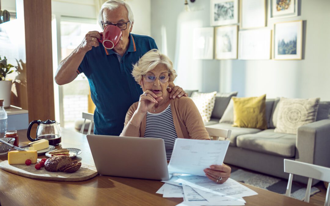 Older couple discussing an inherited IRA and looking at their finances