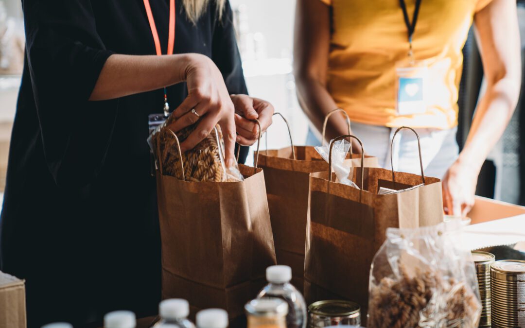 Woman making a charitable contribuion through bagging food for those in need