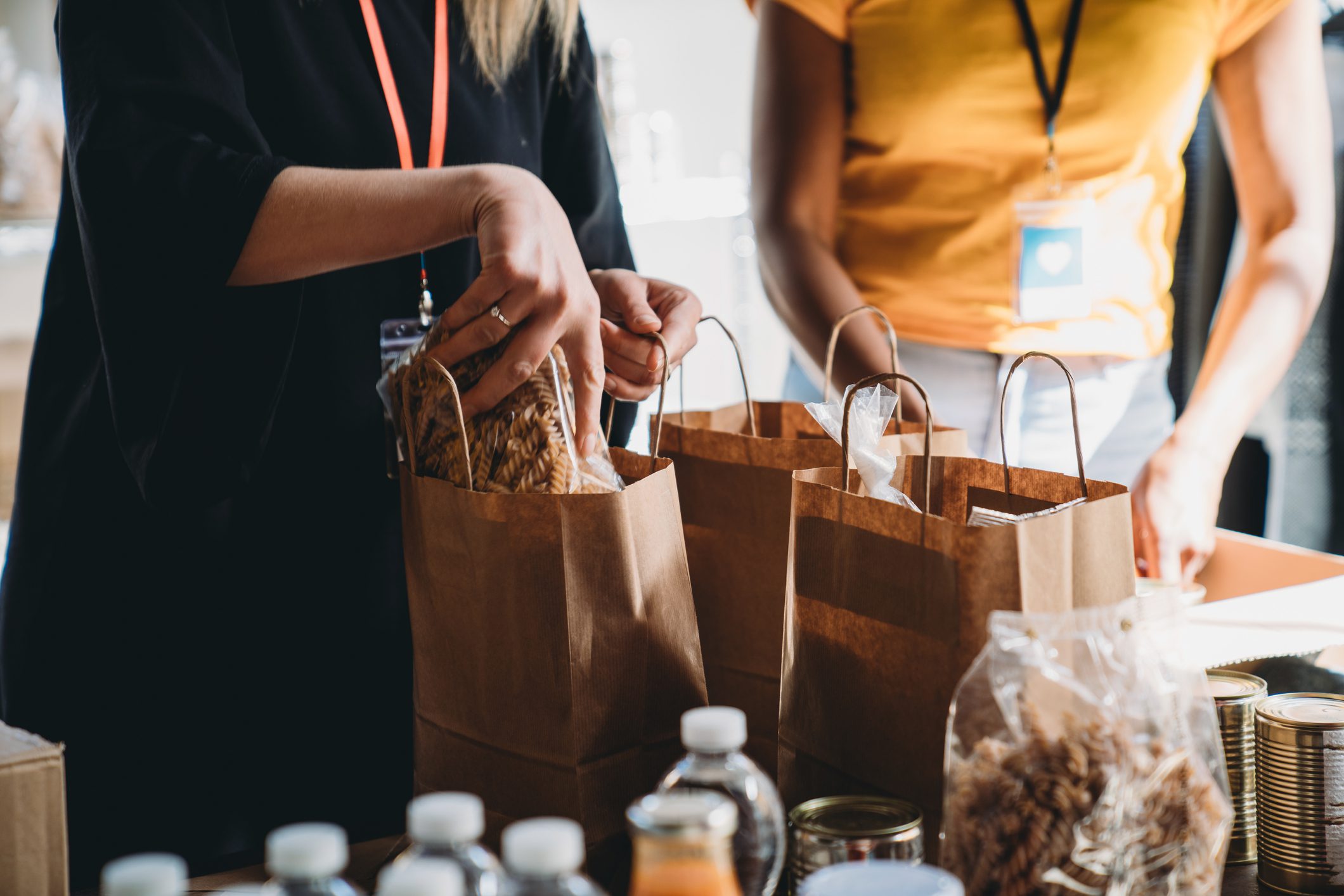 Woman making a charitable contribuion through bagging food for those in need