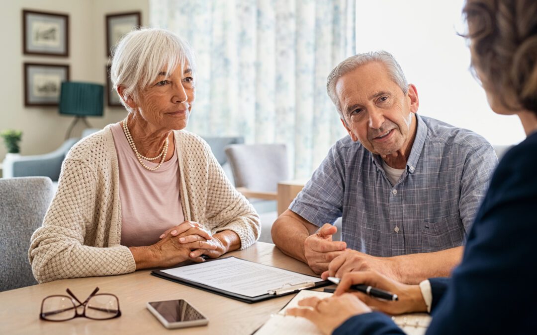 Senior man and woman meeting medical adviser for health insurance at home. Old couple planning their investments with financial advisor after retirement at home. Aged couple consulting with insurance agent while sitting together with prospectus at home.