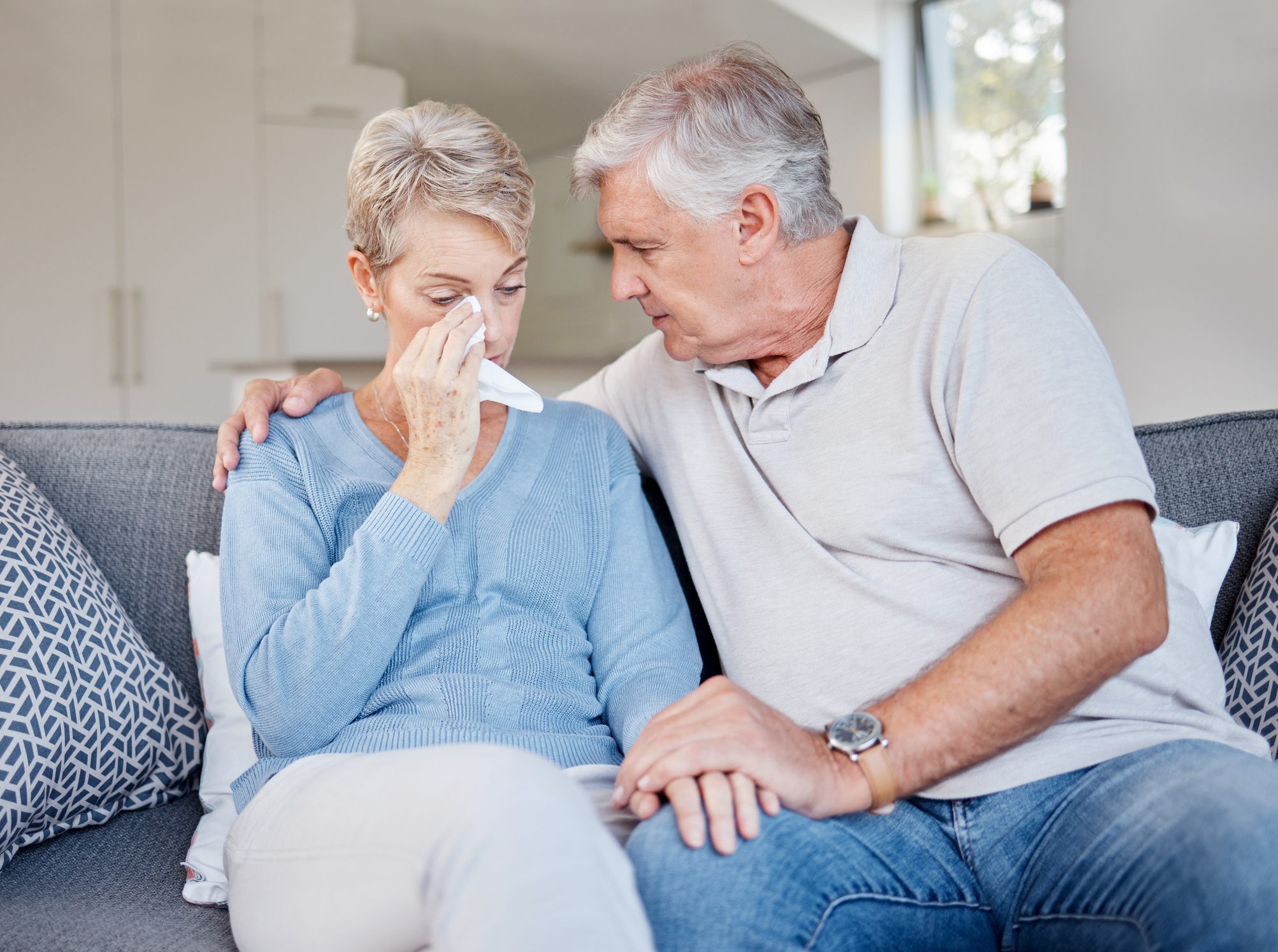 Sad, crying and support of senior couple empathy, trust and helping for mental health problem, divorce or cancer with holding hands. Love of old couple hand holding for bad news, depression or death