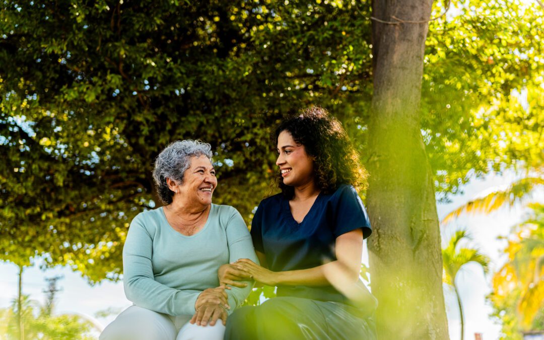 Home caregiver and senior woman talking outdoors