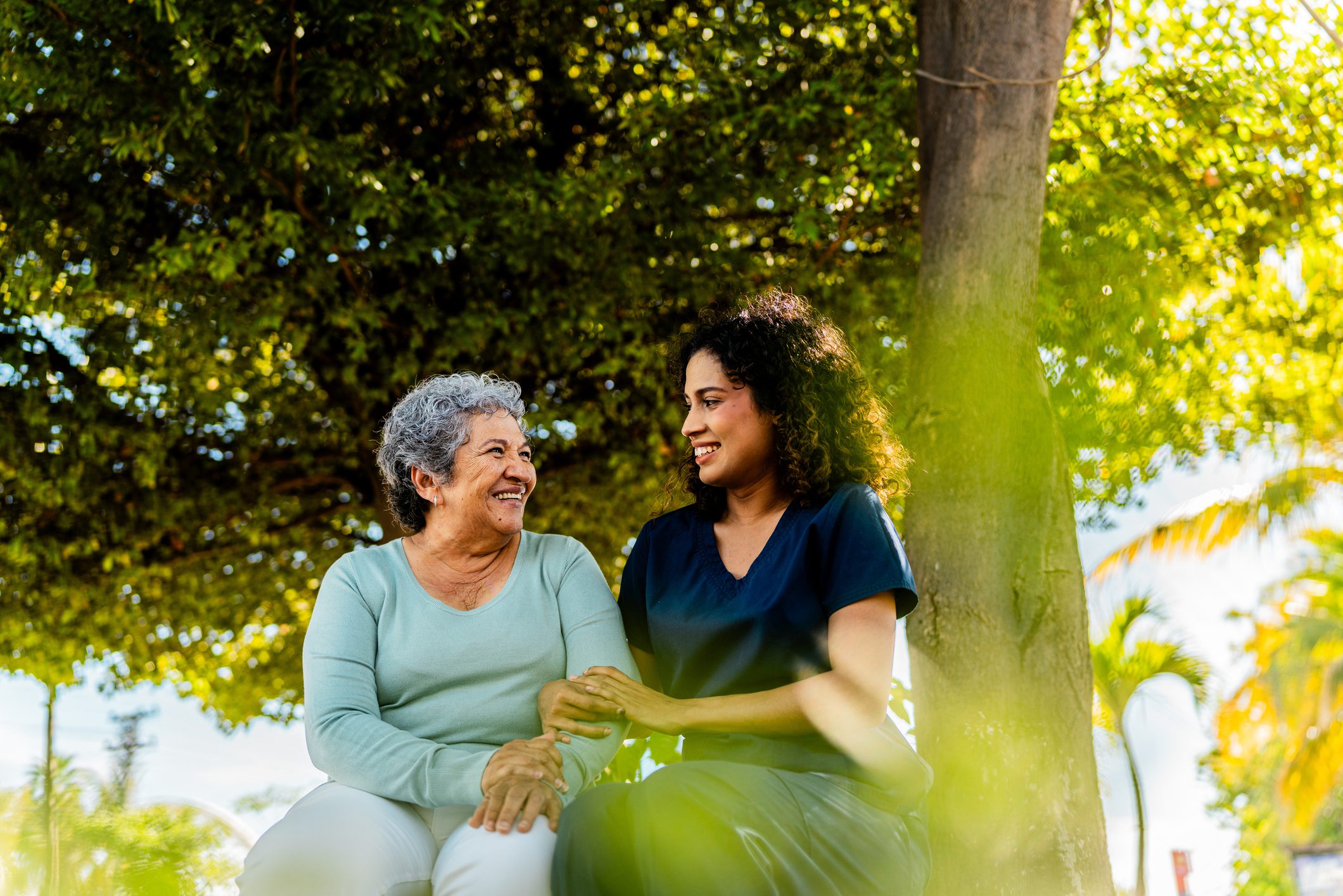 Home caregiver and senior woman talking outdoors Home caregiver and senior woman talking outdoors