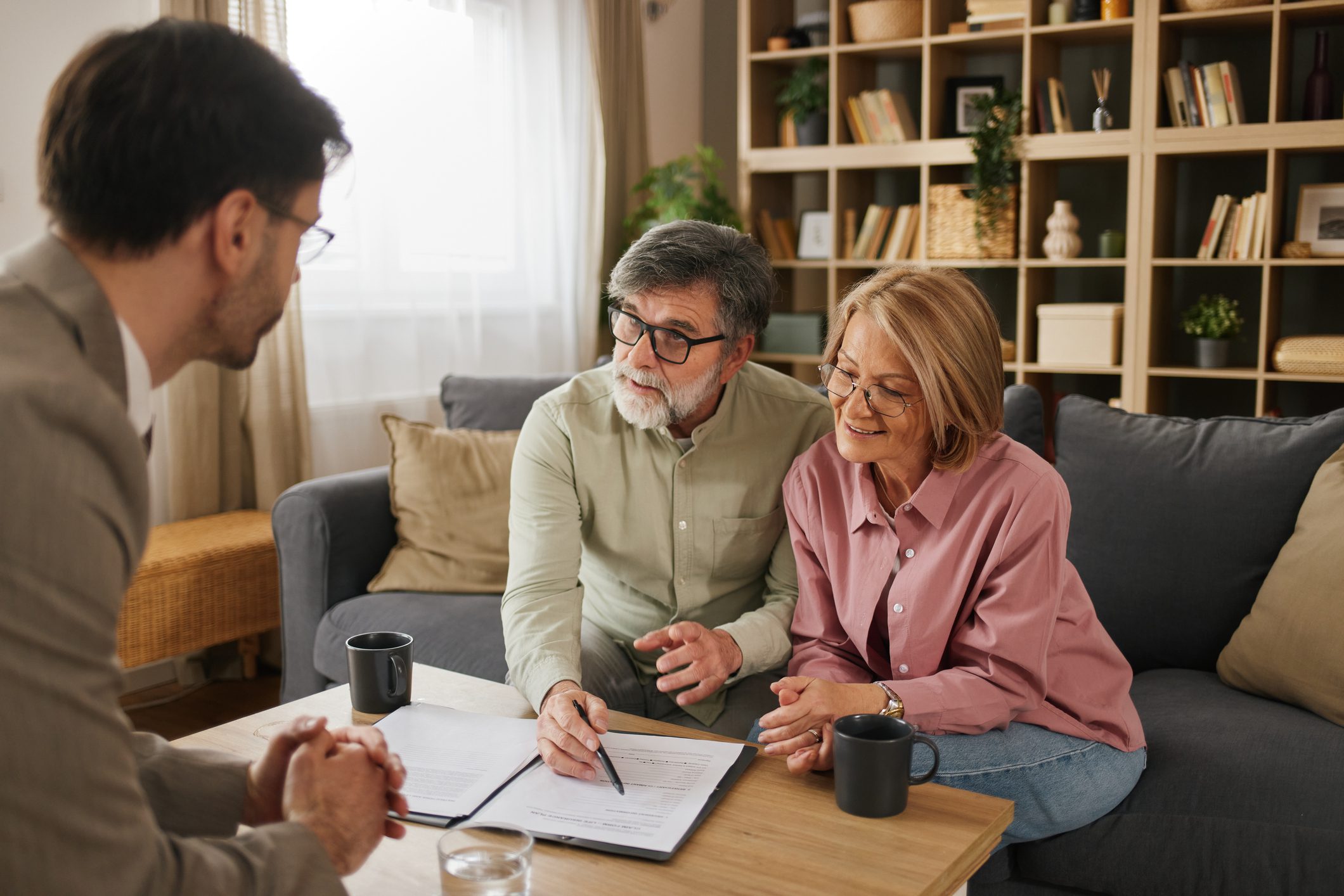 Senior couple meeting financial advisor, discussing life insurance and financial planning
