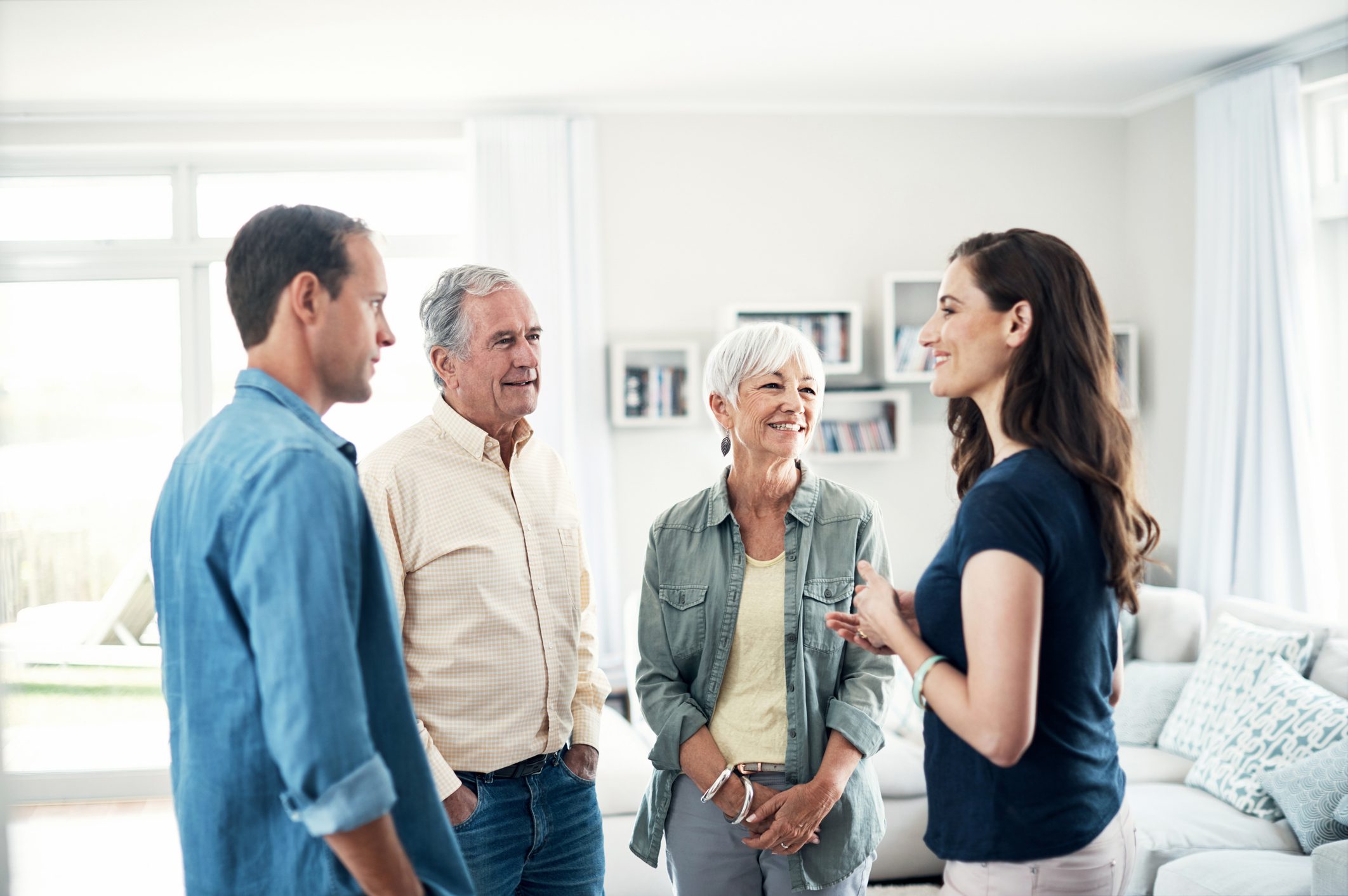 Shot of a young couple and their elderly parent spending some time together at home